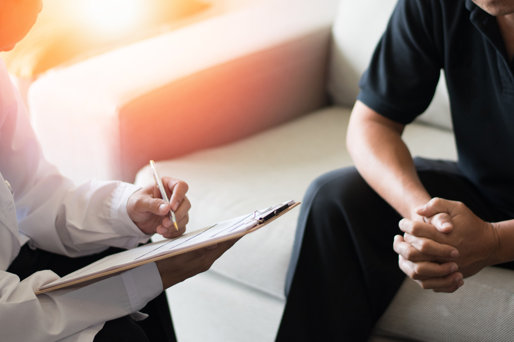 man at the doctor sitting on couch